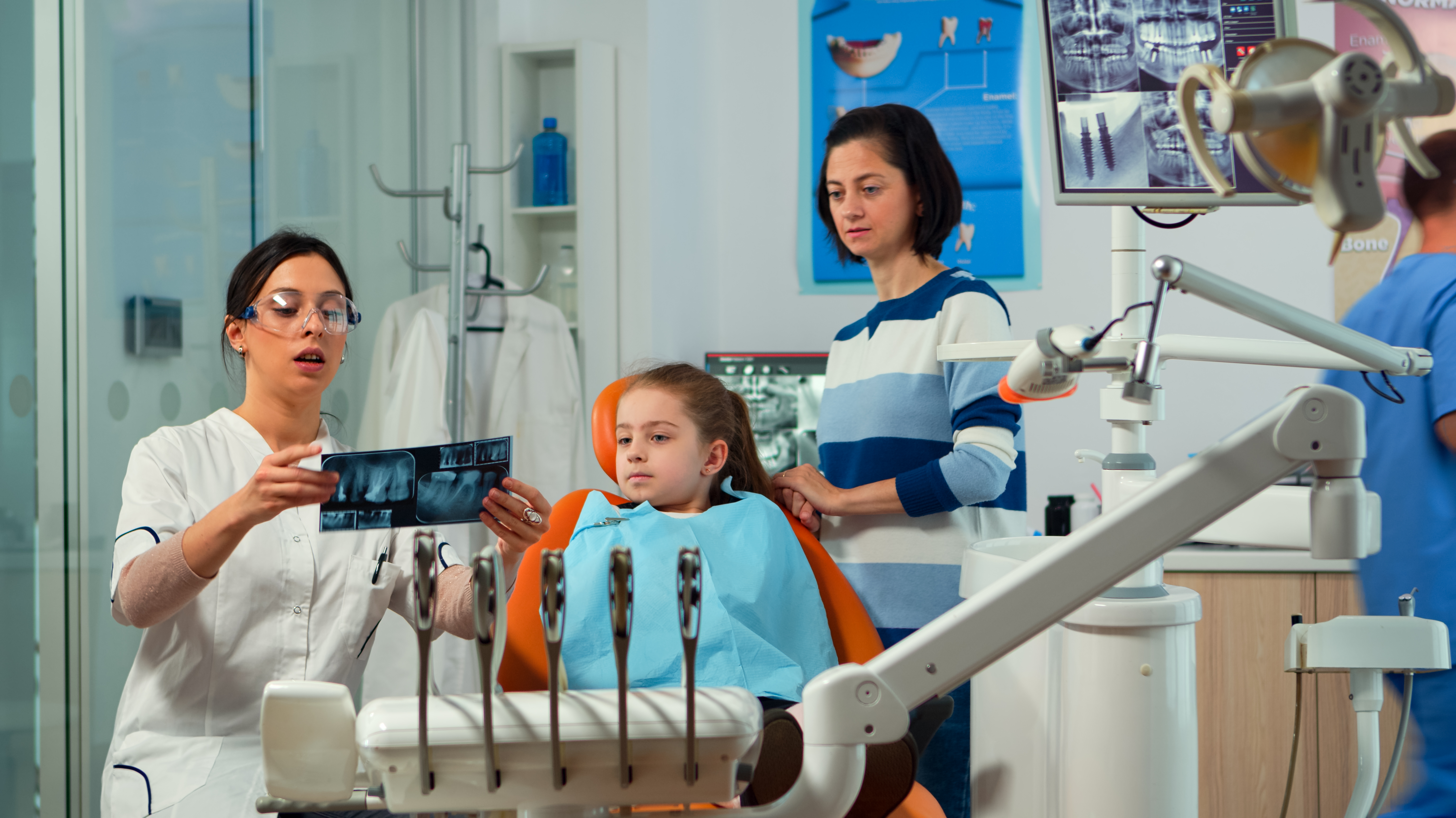 <a href="https://www.freepik.com/free-photo/pediatric-woman-dentist-treating-little-girl-patient-modern-stomatological-dentistry-office-showing-teeth-x-ray-explaining-mother-dental-intervention-visiting-dentist-with-children_17875139.htm#from_element=cross_selling__photo">Image by DC Studio on Freepik</a>