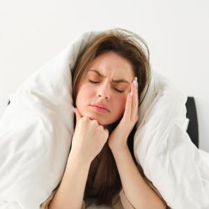 <a href="https://www.freepik.com/free-photo/portrait-woman-rolled-blankets-bed-frowning-feeling-unwell-has-hangover-headache_85939069.htm#fromView=search&page=1&position=1&uuid=2535d884-c62c-45b2-b76c-5bcf53c53ae3&query=bruxism+sleeping+jaw+pain">Image by benzoix on Freepik</a>